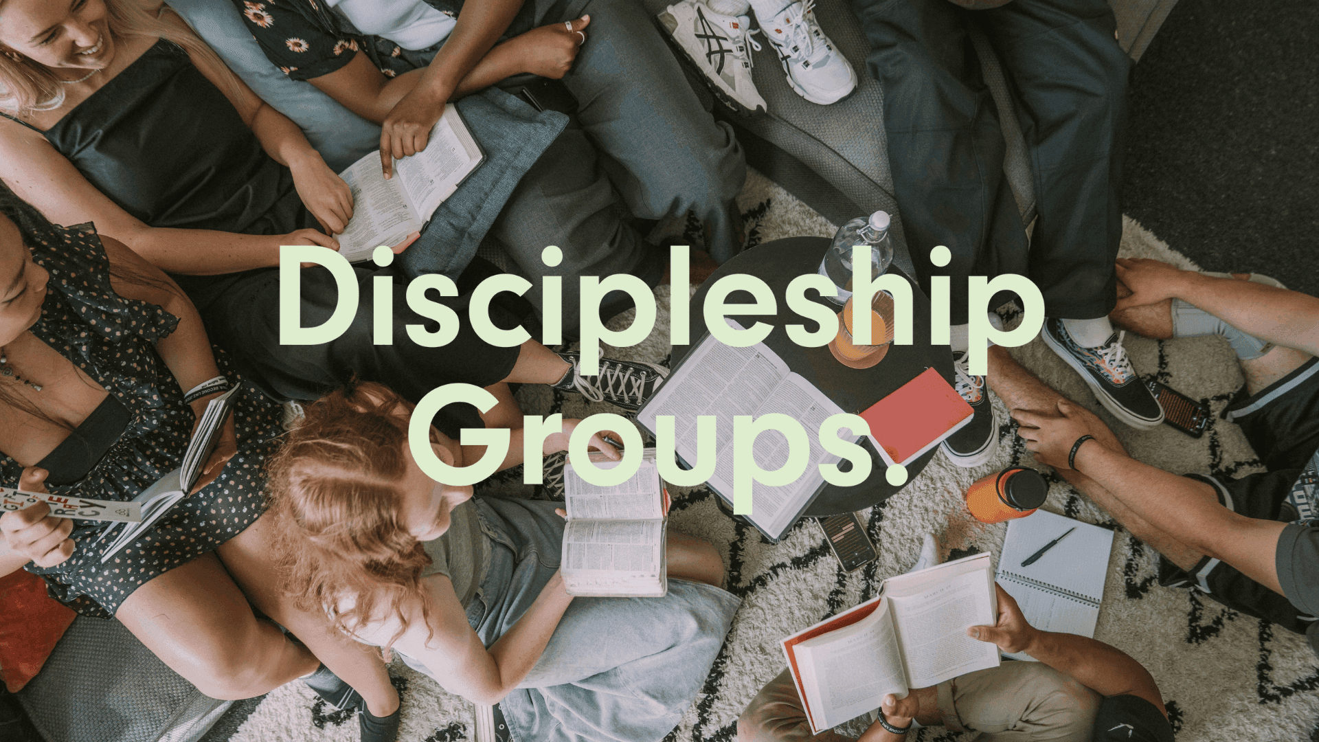 Discipleship Groups logo with image behind the logo of people sitting around on chairs and the floor with bibles, notebooks, pens and drinks while they talk and laugh